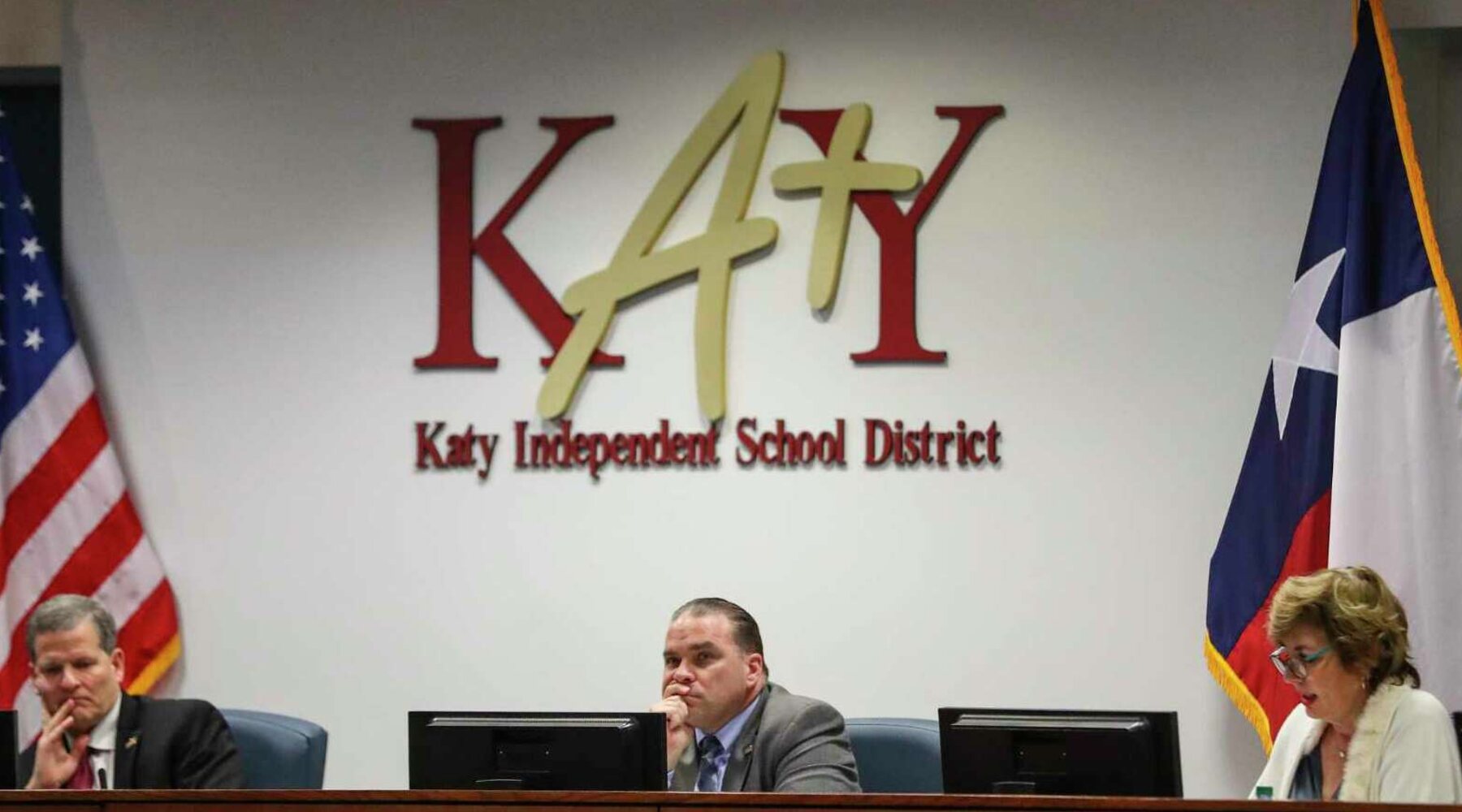 Three trustees at the Katy ISD board dais beneath the district's Katy 4 Y logo.