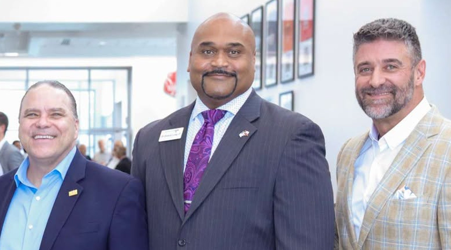 Robert Long III, center, photographed with two other men at an indoor event.