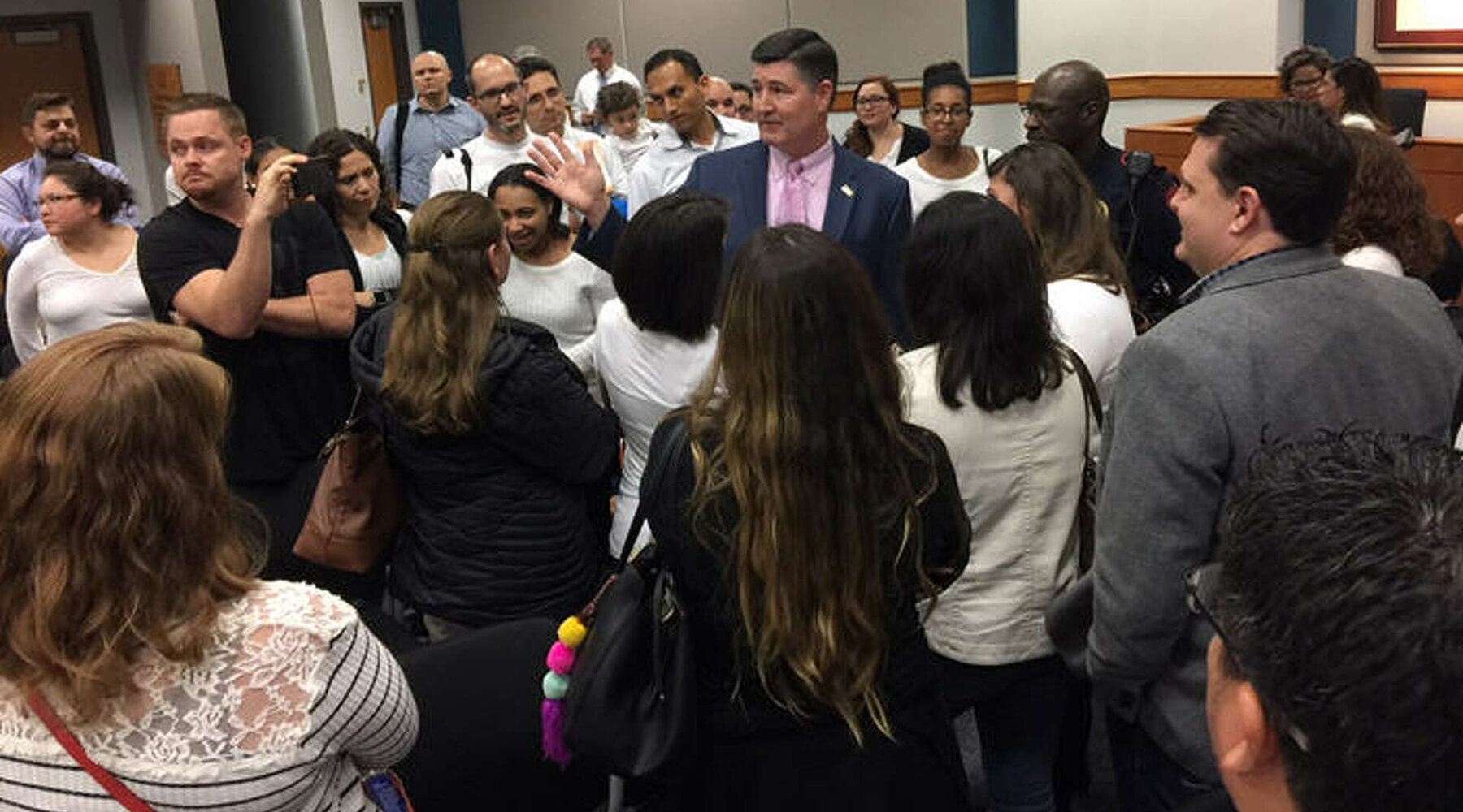 Superintendent surrounded by Two-Way Immersion parents at a Katy ISD board meeting, 2018.